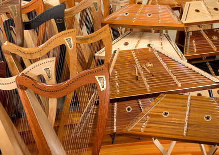 Picture of many Dusty Strings harps and hammered dulcimers